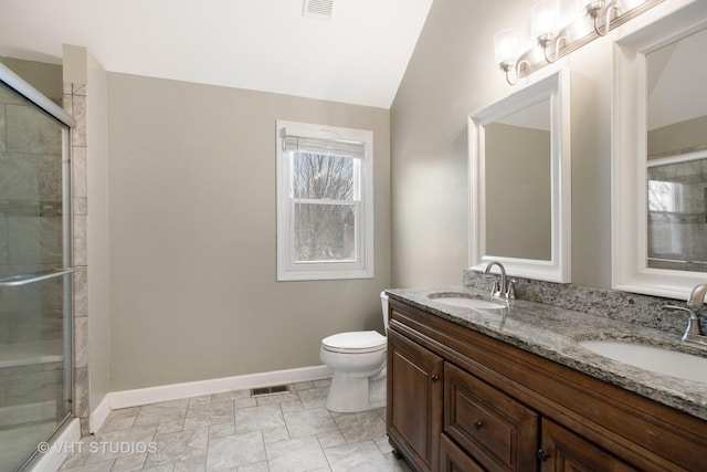 bathroom featuring vanity, vaulted ceiling, a shower with shower door, and toilet