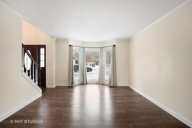 empty room with ornamental molding and dark hardwood / wood-style flooring