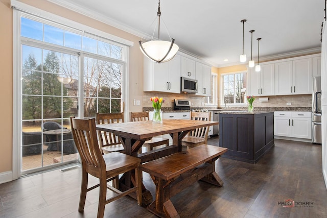 dining room with visible vents, dark wood-style flooring, and ornamental molding