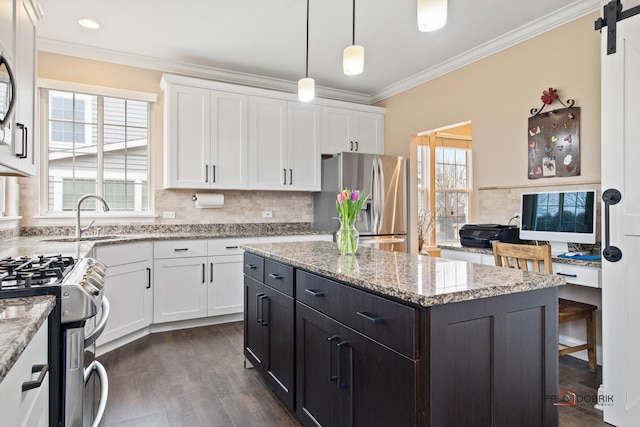 kitchen with a sink, appliances with stainless steel finishes, and white cabinets