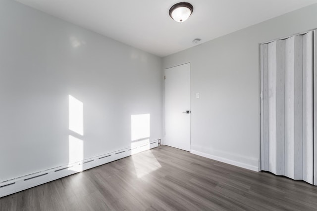 interior space featuring a closet, dark hardwood / wood-style flooring, and a baseboard radiator