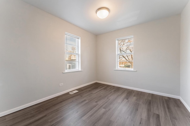 unfurnished room featuring dark hardwood / wood-style floors