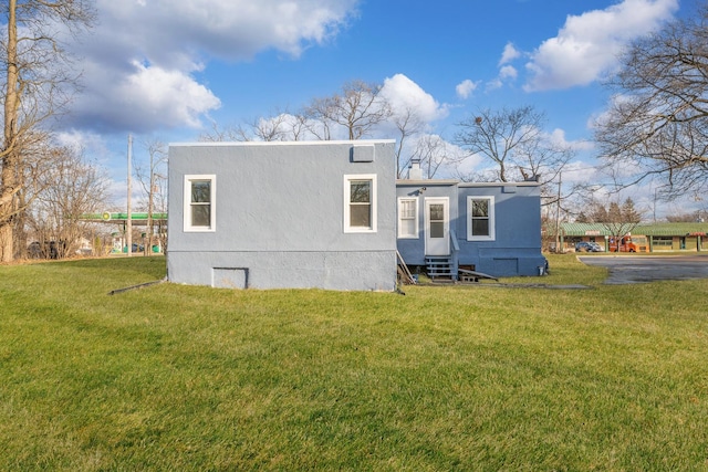 rear view of property featuring a yard