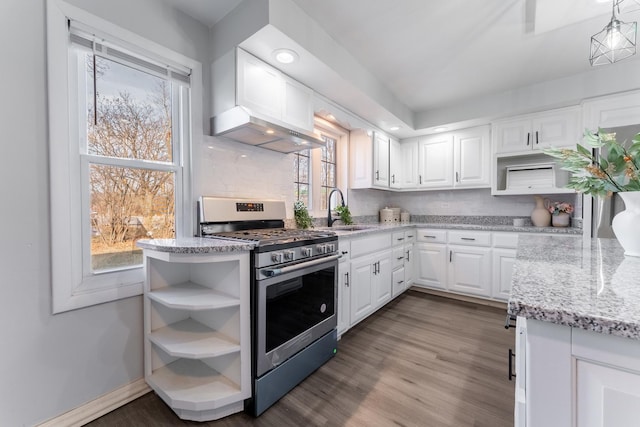 kitchen with extractor fan, gas range, sink, white cabinets, and light stone counters