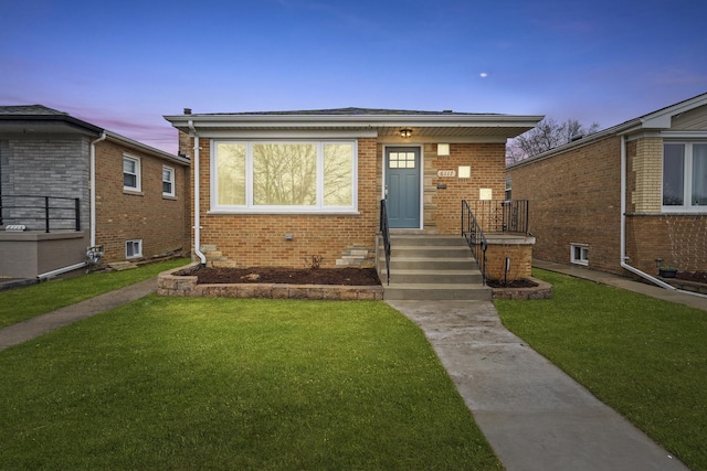 bungalow-style home featuring a yard