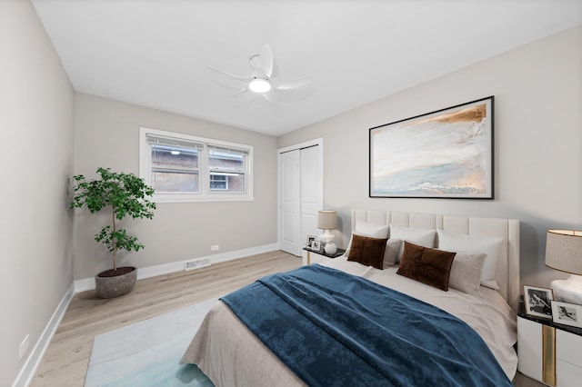 bedroom with ceiling fan, a closet, and light wood-type flooring