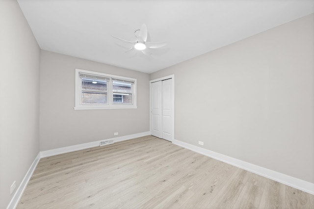 unfurnished bedroom with ceiling fan, a closet, and light hardwood / wood-style flooring