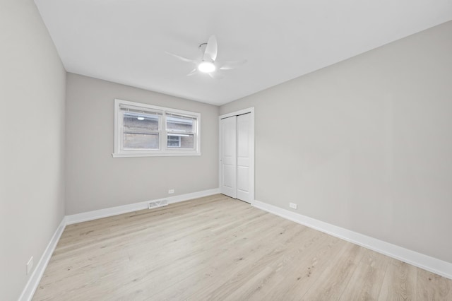 unfurnished bedroom featuring ceiling fan, a closet, and light hardwood / wood-style floors