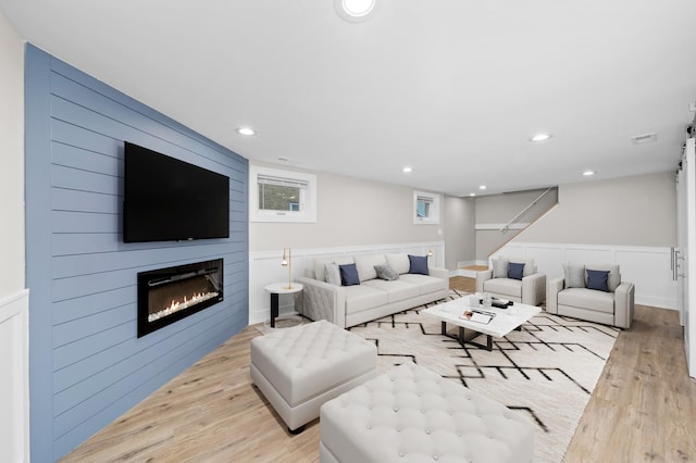 living room with a fireplace and light hardwood / wood-style flooring