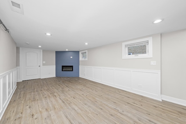 unfurnished living room with a fireplace and light hardwood / wood-style flooring