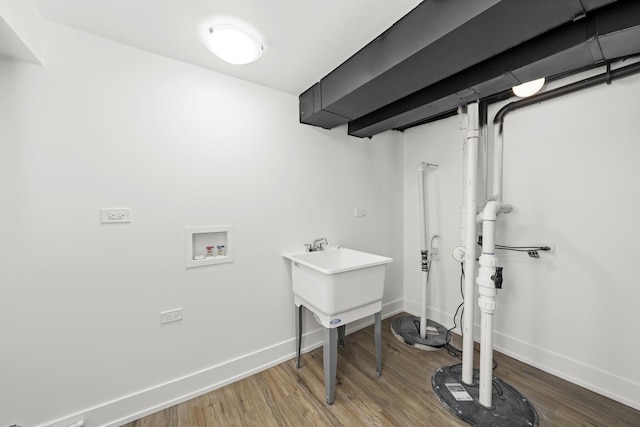 laundry room with washer hookup and hardwood / wood-style flooring