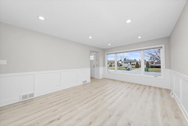 empty room with light hardwood / wood-style floors