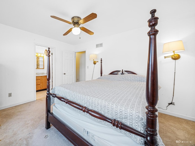 bedroom featuring visible vents, light colored carpet, connected bathroom, and baseboards