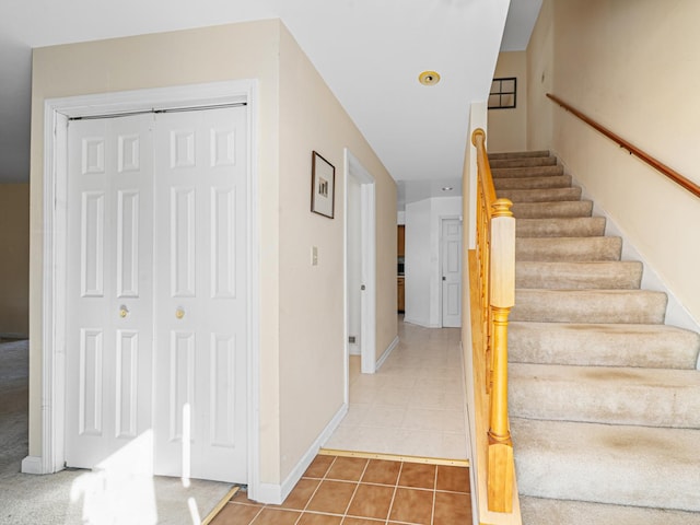 stairway featuring tile patterned floors and baseboards