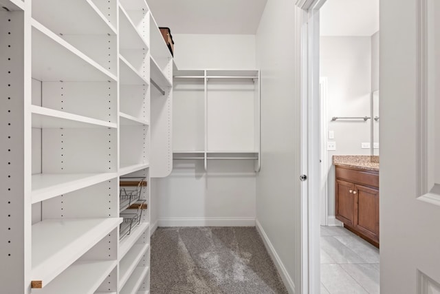 walk in closet featuring light carpet