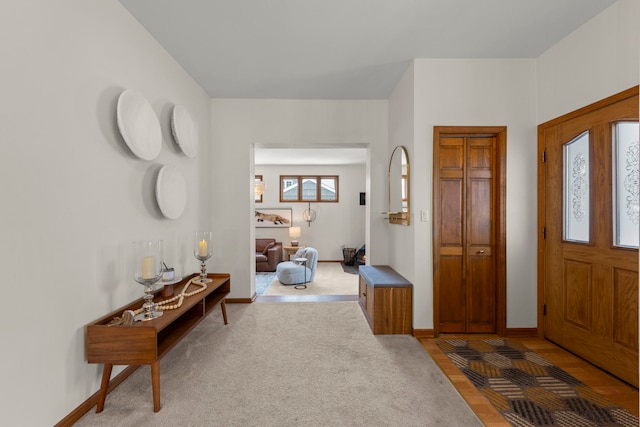 view of carpeted foyer entrance