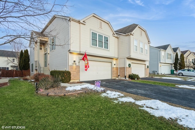 view of front of home featuring a garage and a lawn