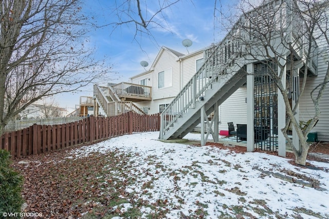 view of snow covered back of property