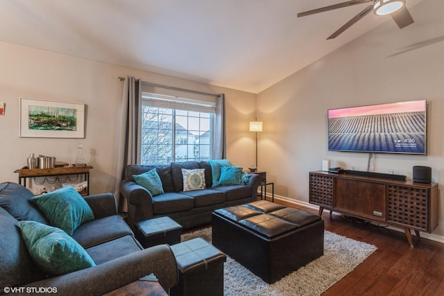 living room featuring vaulted ceiling, ceiling fan, and dark hardwood / wood-style flooring