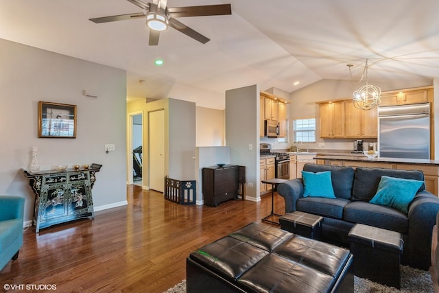 living room featuring lofted ceiling, dark hardwood / wood-style floors, sink, and ceiling fan with notable chandelier