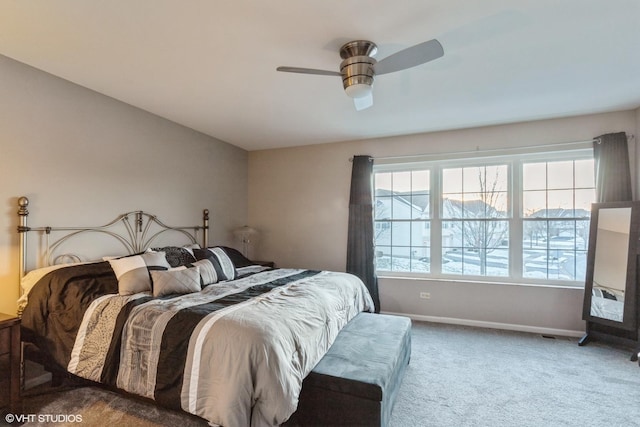 bedroom featuring ceiling fan, multiple windows, and carpet flooring