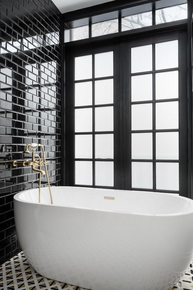 bathroom featuring tile patterned flooring and a tub