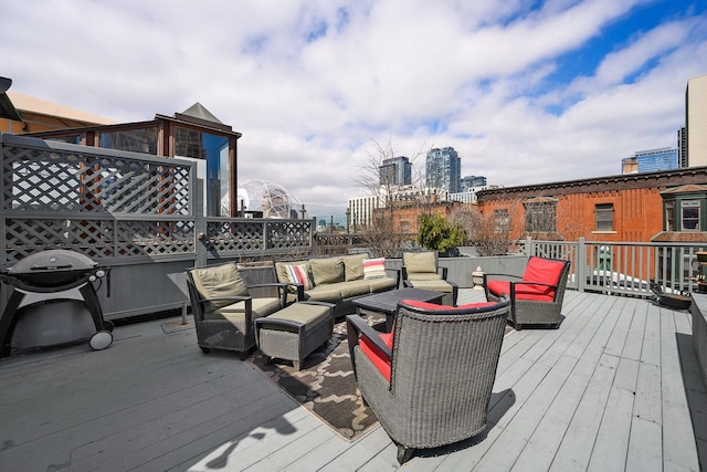 wooden deck featuring grilling area and an outdoor hangout area