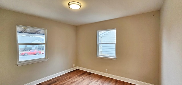 empty room with hardwood / wood-style flooring