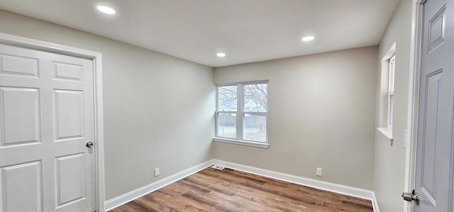 spare room featuring a healthy amount of sunlight and hardwood / wood-style floors