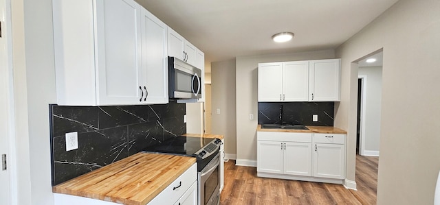 kitchen with appliances with stainless steel finishes and white cabinetry