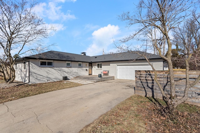 single story home featuring central AC unit and a garage