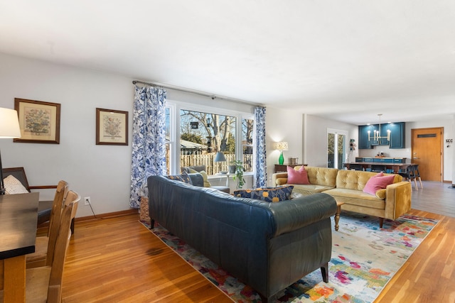 living room featuring light hardwood / wood-style flooring and a notable chandelier