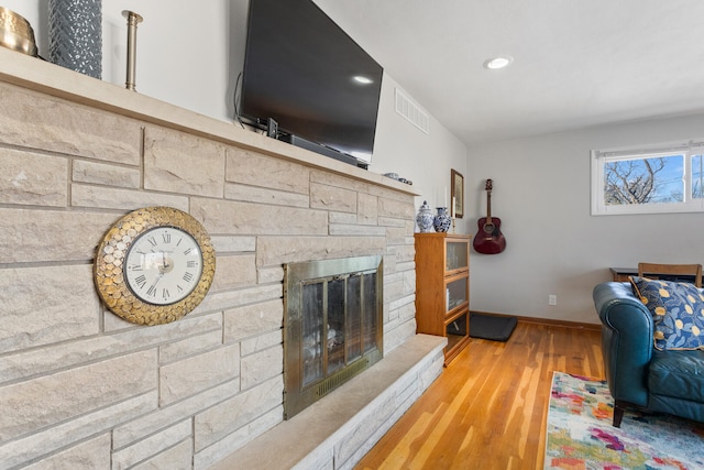 living room with hardwood / wood-style flooring and a fireplace