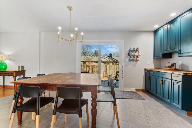 tiled dining room with a notable chandelier