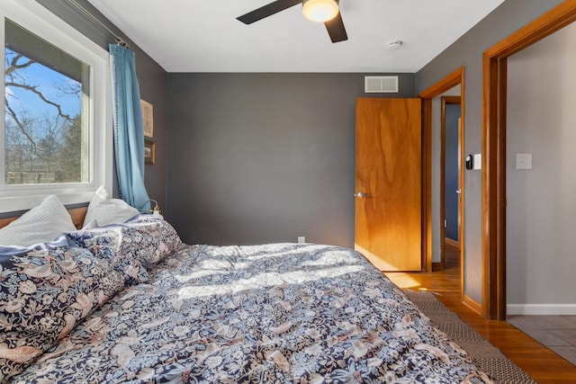 bedroom with ceiling fan and hardwood / wood-style floors