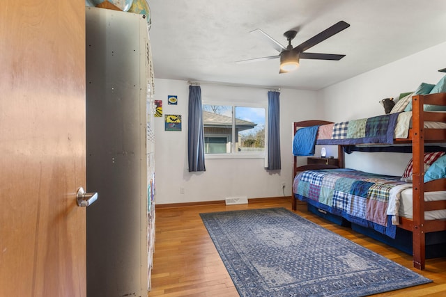 bedroom with ceiling fan and hardwood / wood-style floors