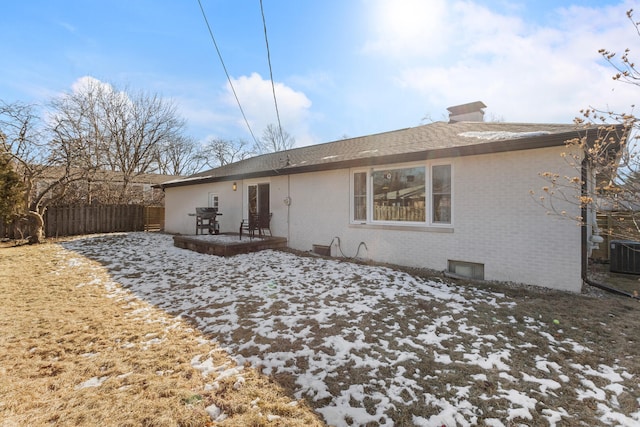 snow covered house featuring central air condition unit