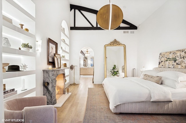 bedroom featuring hardwood / wood-style flooring and high vaulted ceiling