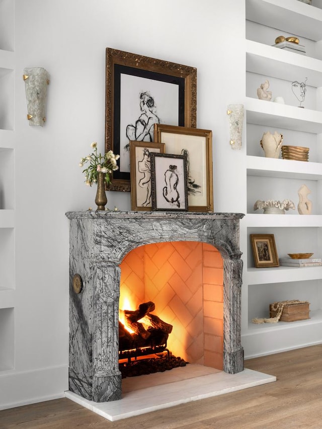 interior details featuring hardwood / wood-style floors and built in shelves