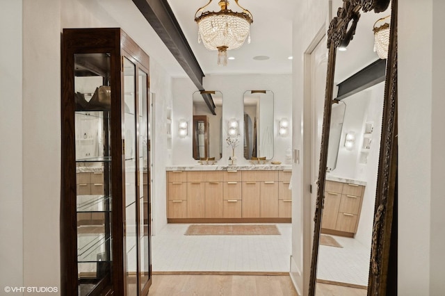 corridor featuring light hardwood / wood-style floors and a notable chandelier