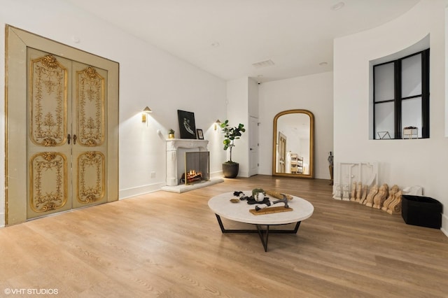 sitting room with wood-type flooring