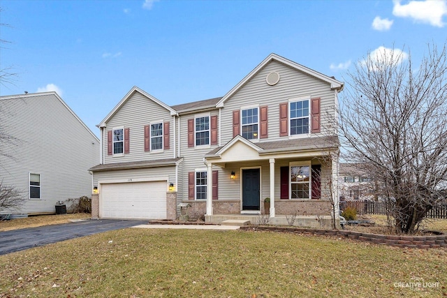 view of front of house featuring a garage and a front yard