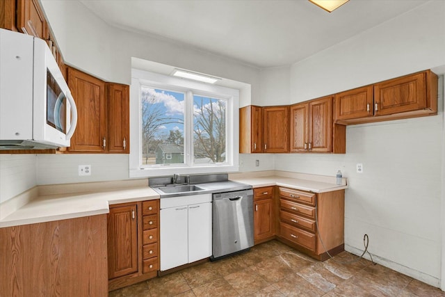 kitchen with tasteful backsplash, dishwasher, and sink