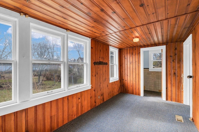 unfurnished sunroom featuring a wealth of natural light and wood ceiling