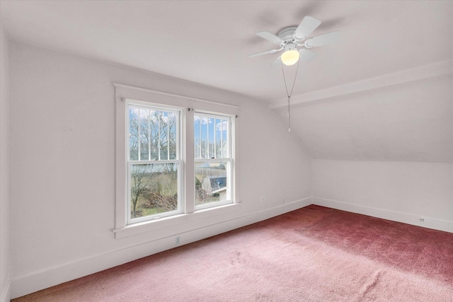 additional living space with lofted ceiling, a wealth of natural light, ceiling fan, and carpet