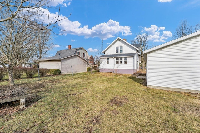 rear view of house featuring a yard