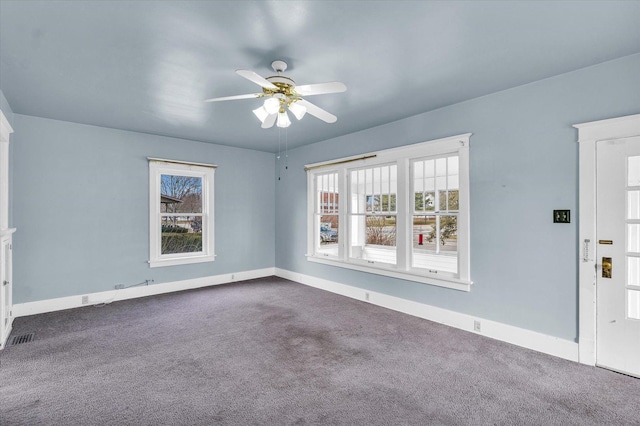 carpeted spare room featuring ceiling fan