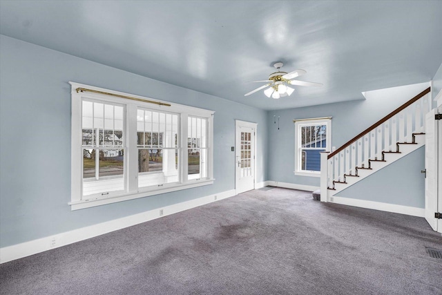 interior space with carpet floors, plenty of natural light, and ceiling fan