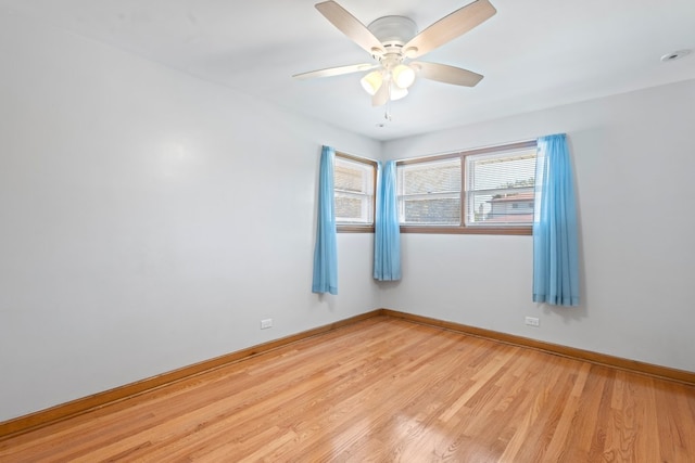 spare room with ceiling fan and light wood-type flooring