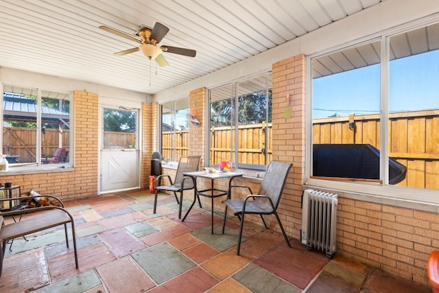 sunroom / solarium with radiator heating unit and ceiling fan